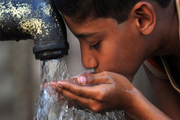 A child drinking clean water from a tube well